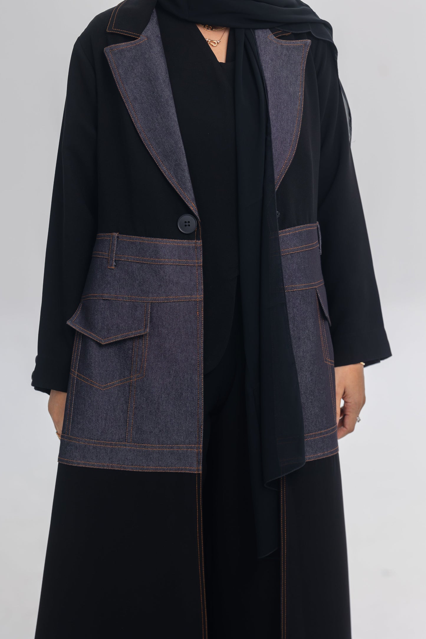 Black crepe abaya with blue denim fabric and orange stitching detailing named Blue Stitch