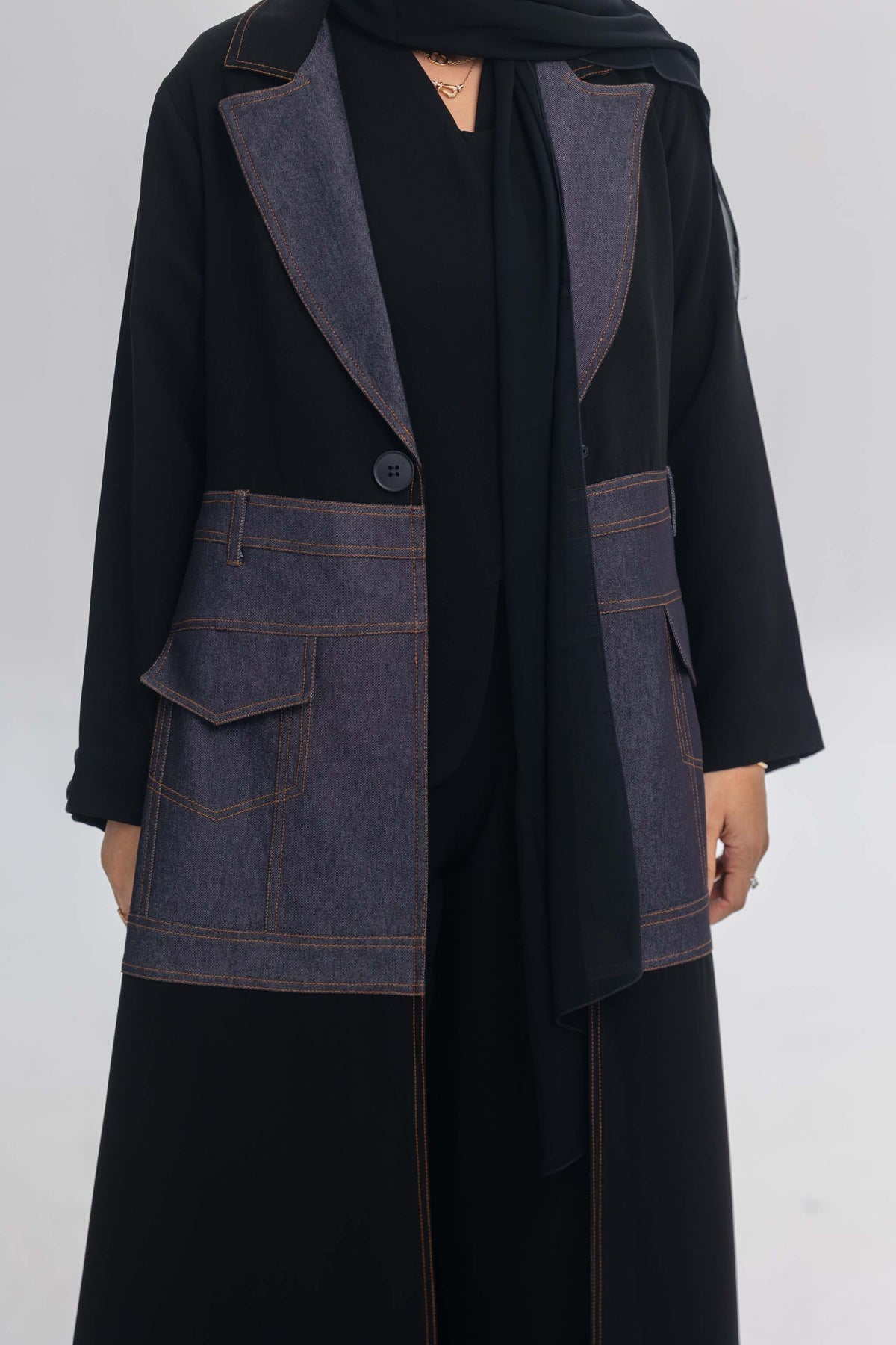 Black crepe abaya with blue denim fabric and orange stitching detailing named Blue Stitch