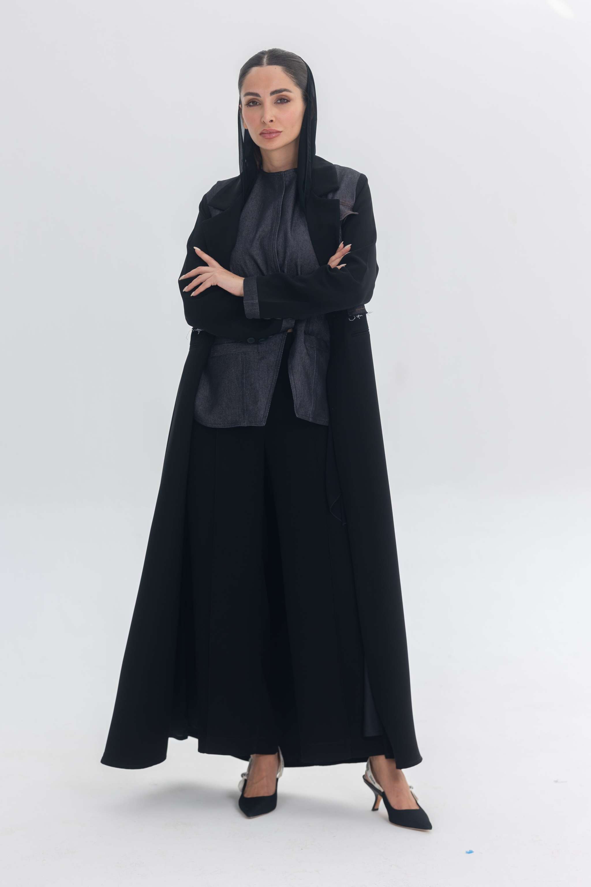 Woman wearing a black crepe abaya with denim accents called Denim Veil, blending modern edge with classic elegance.