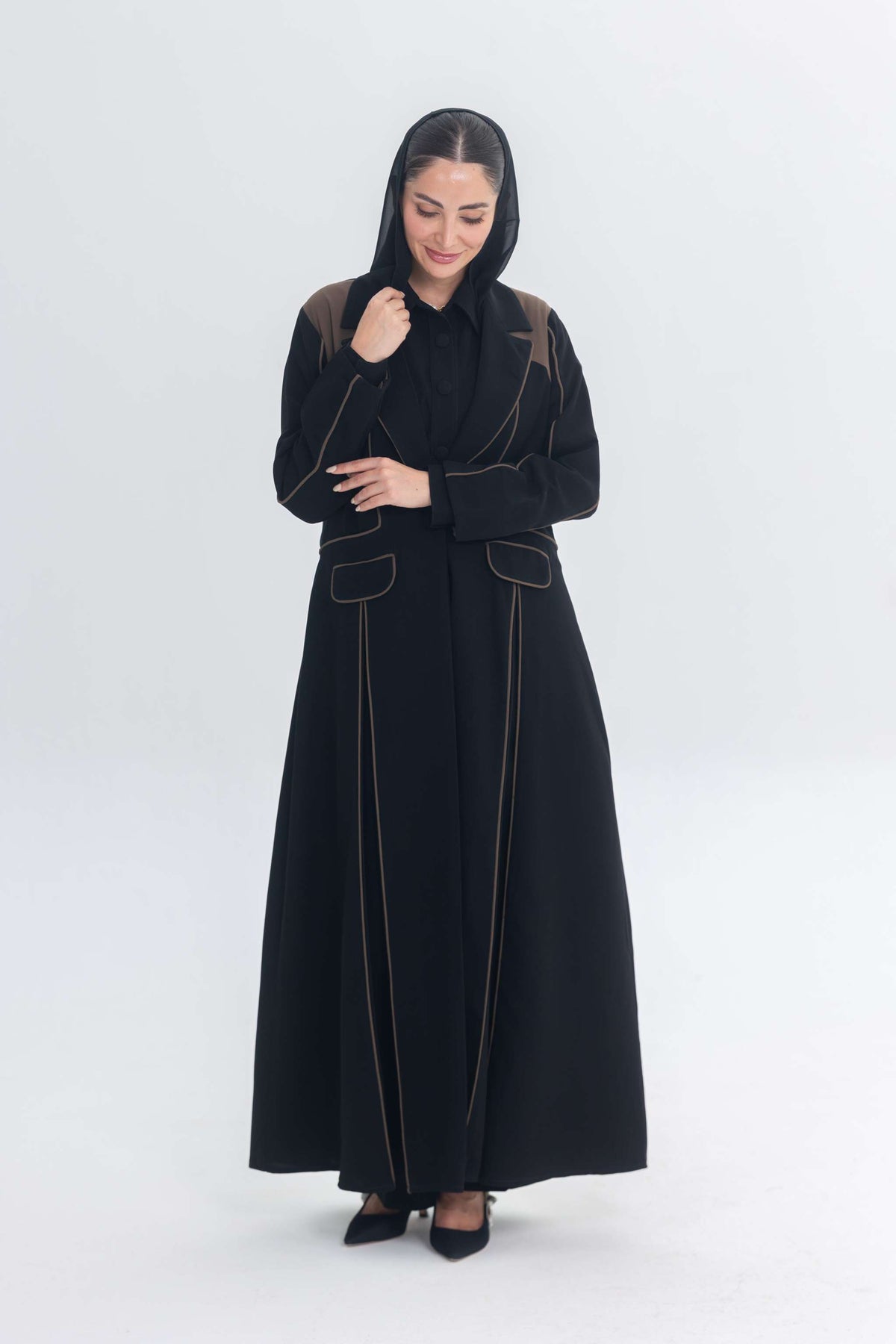 Black abaya with rich brown Cocoa Shadow detailing creating a 3D effect and elegant silhouette.