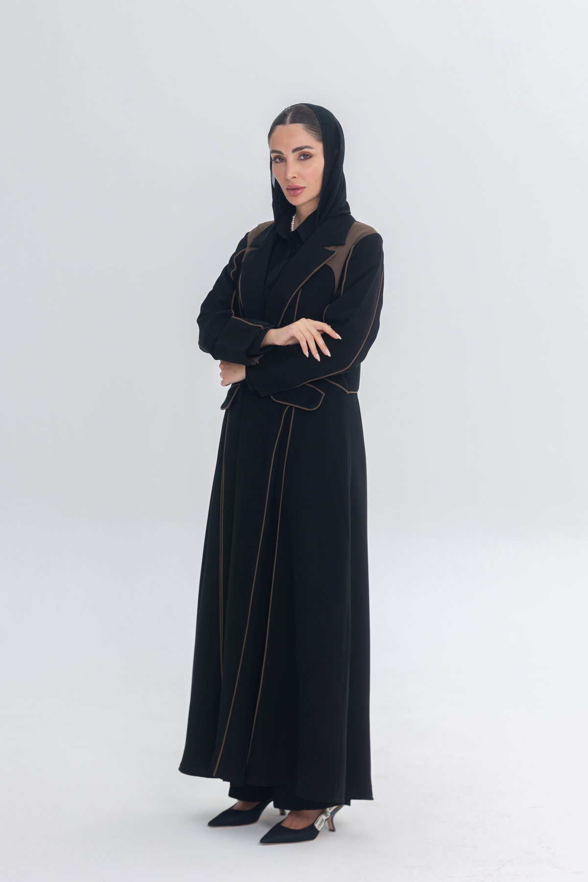 Elegant black abaya with rich brown 3D detailing and tailored accents, named Cocoa Shadow, showcasing a modern yet traditional design.