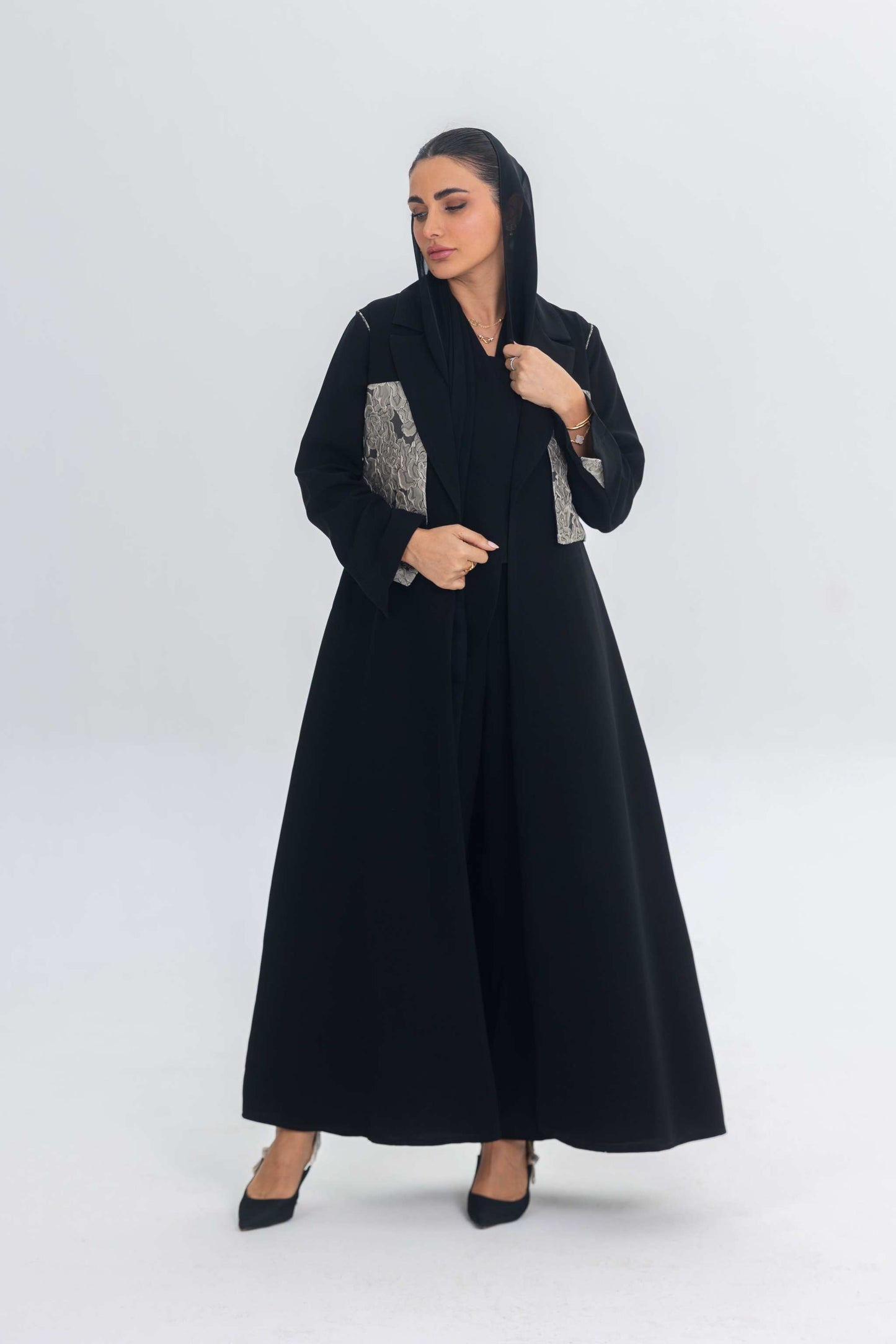 Elegant black crepe abaya with textured jacquard panel and flowing design for modern women