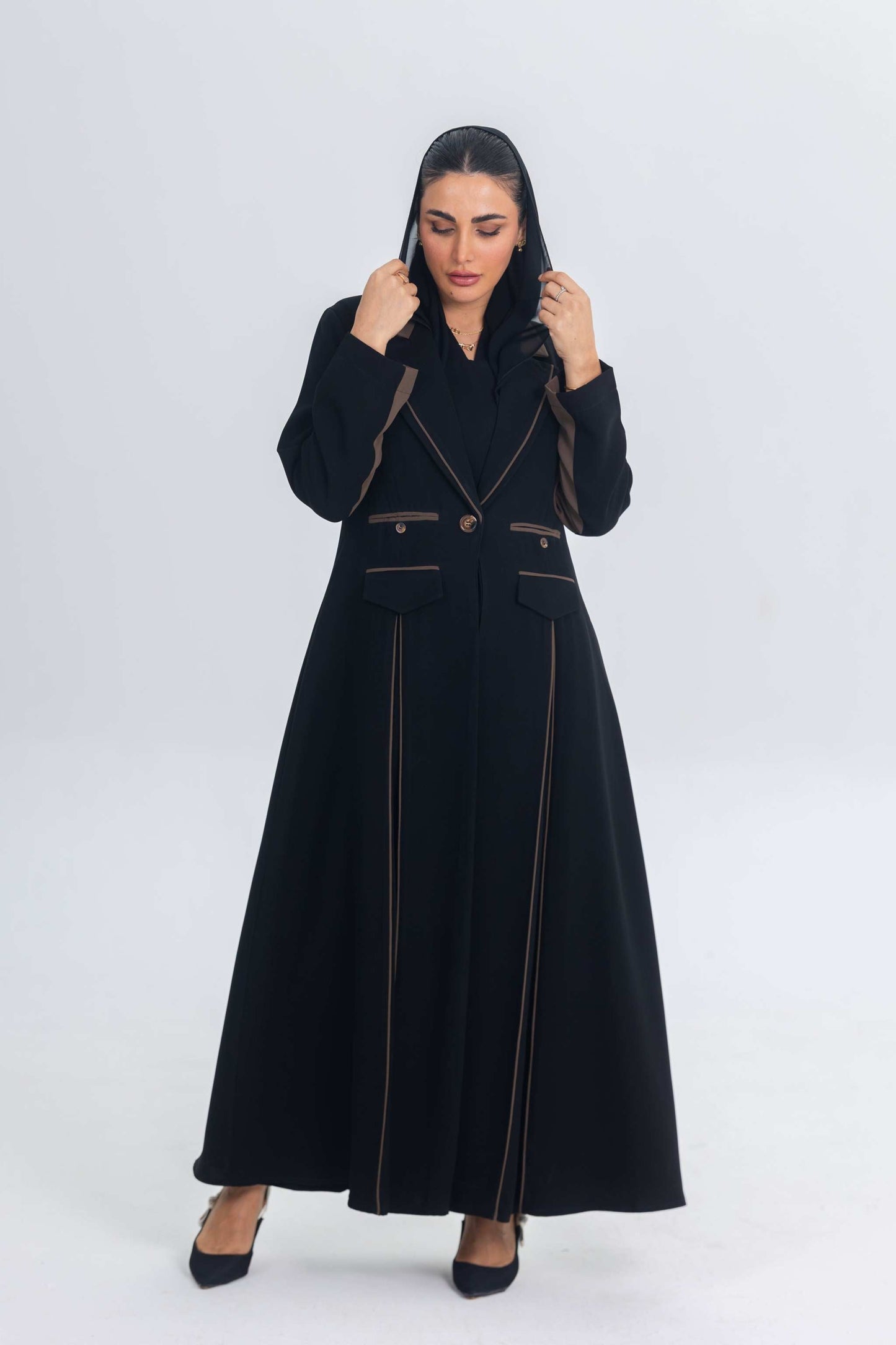 Black crepe blazer abaya with brown trims and elegant tailored silhouette worn by woman