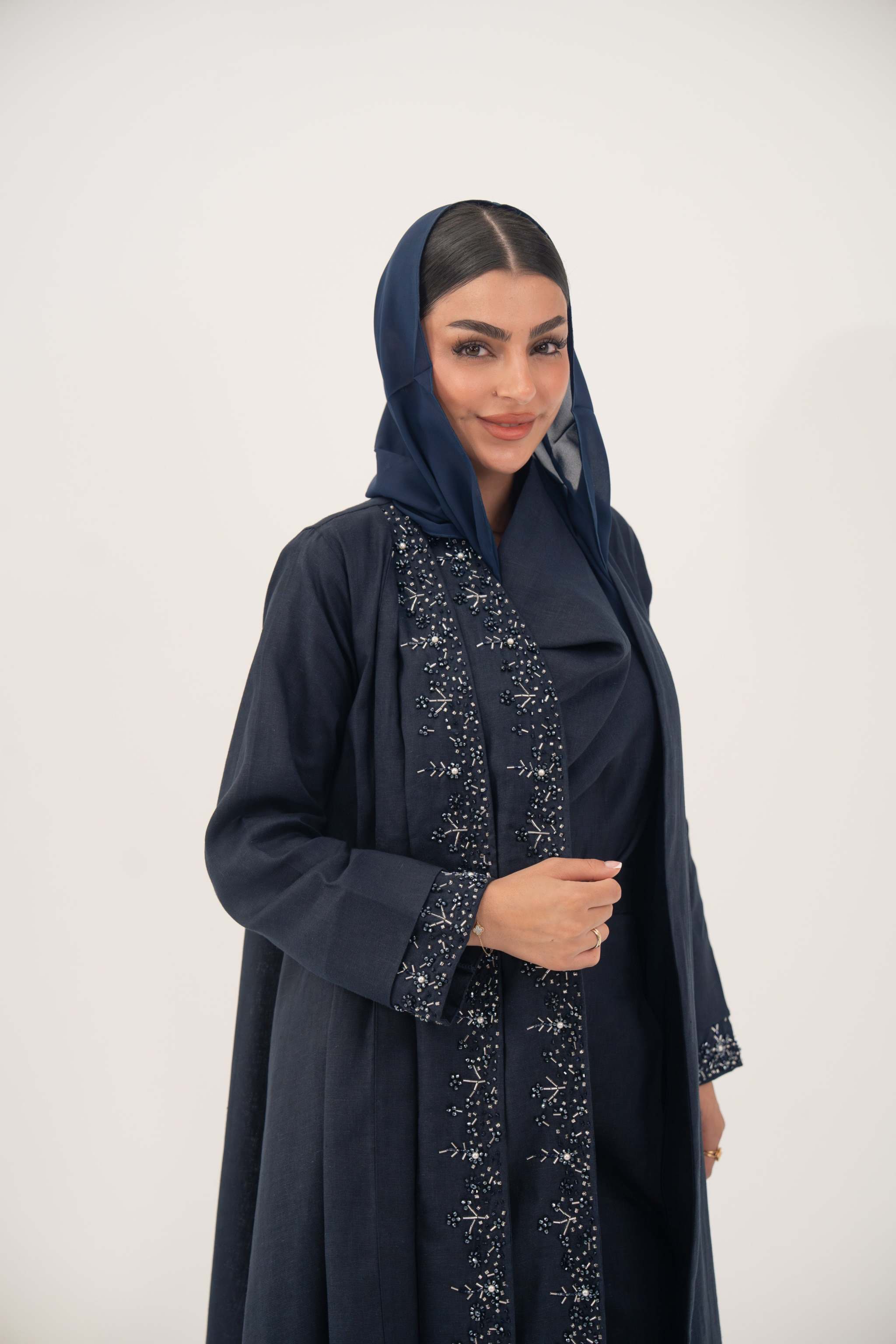 High-quality linen abaya with delicate shak beading on front panels and cuffs, open-front flowy design with structured shoulders