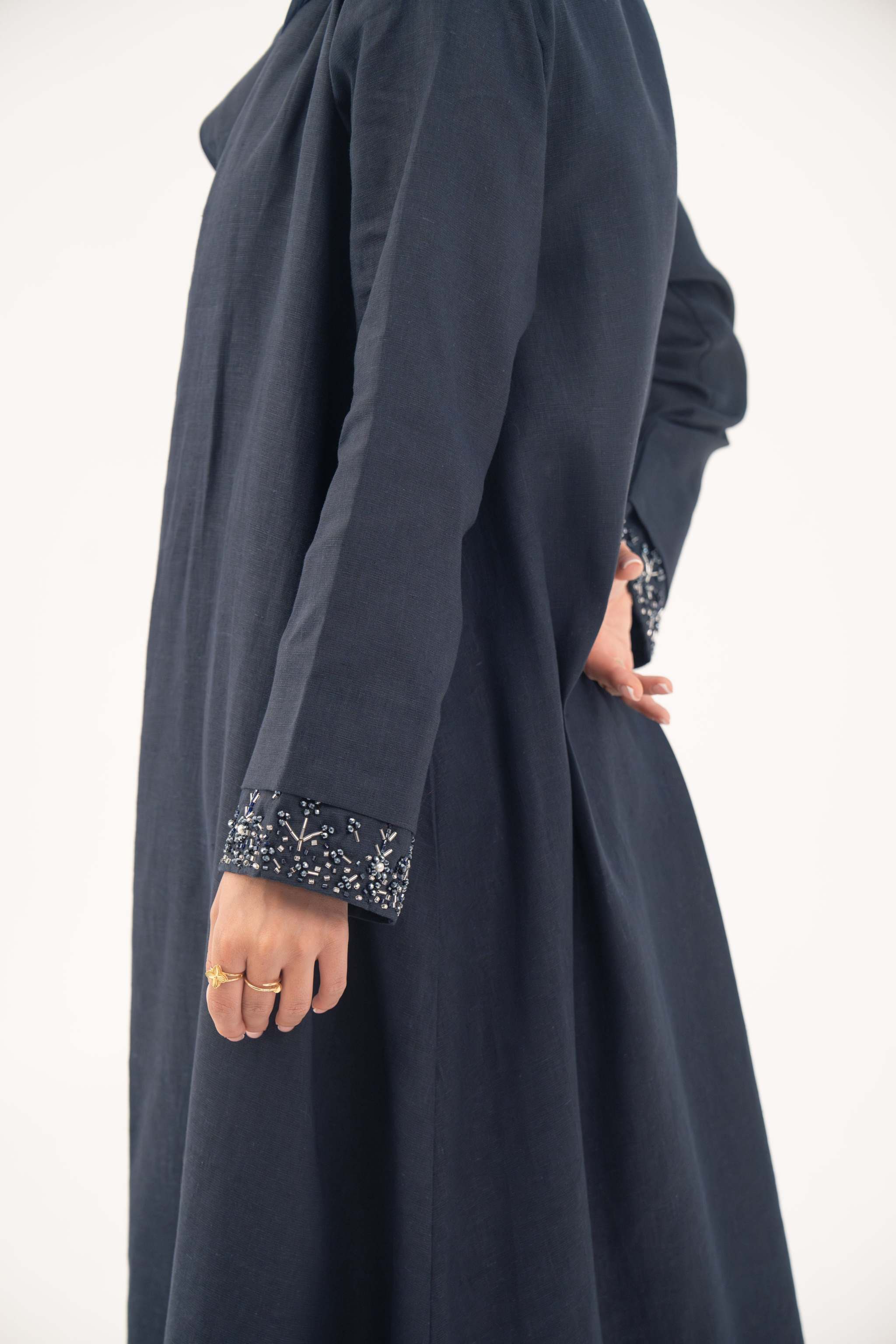 High-quality linen abaya with delicate shak beading on front panels and cuffs, open-front flowy design with structured shoulders
