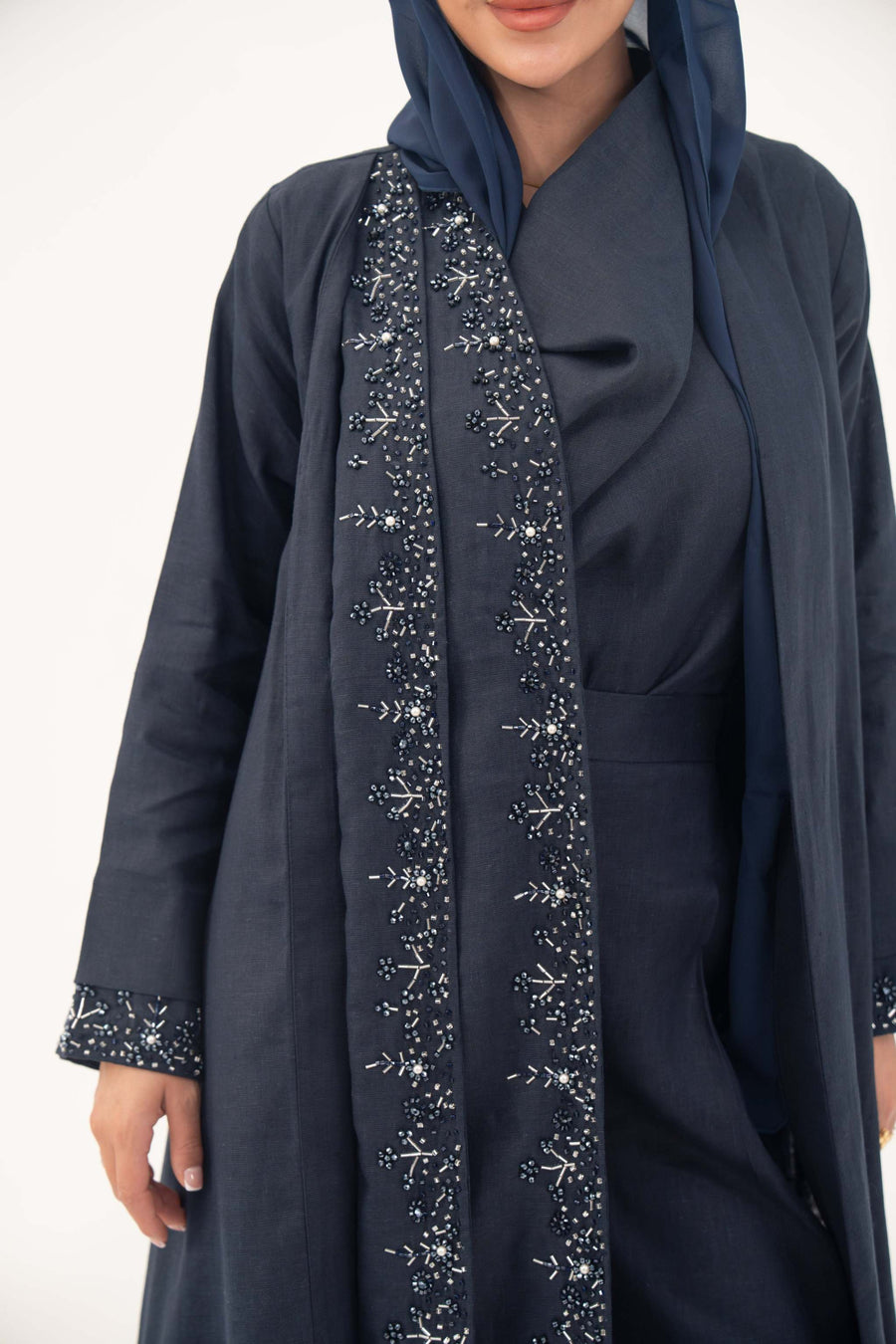 High-quality linen abaya with delicate shak beading on front panels and cuffs, open-front flowy design with structured shoulders