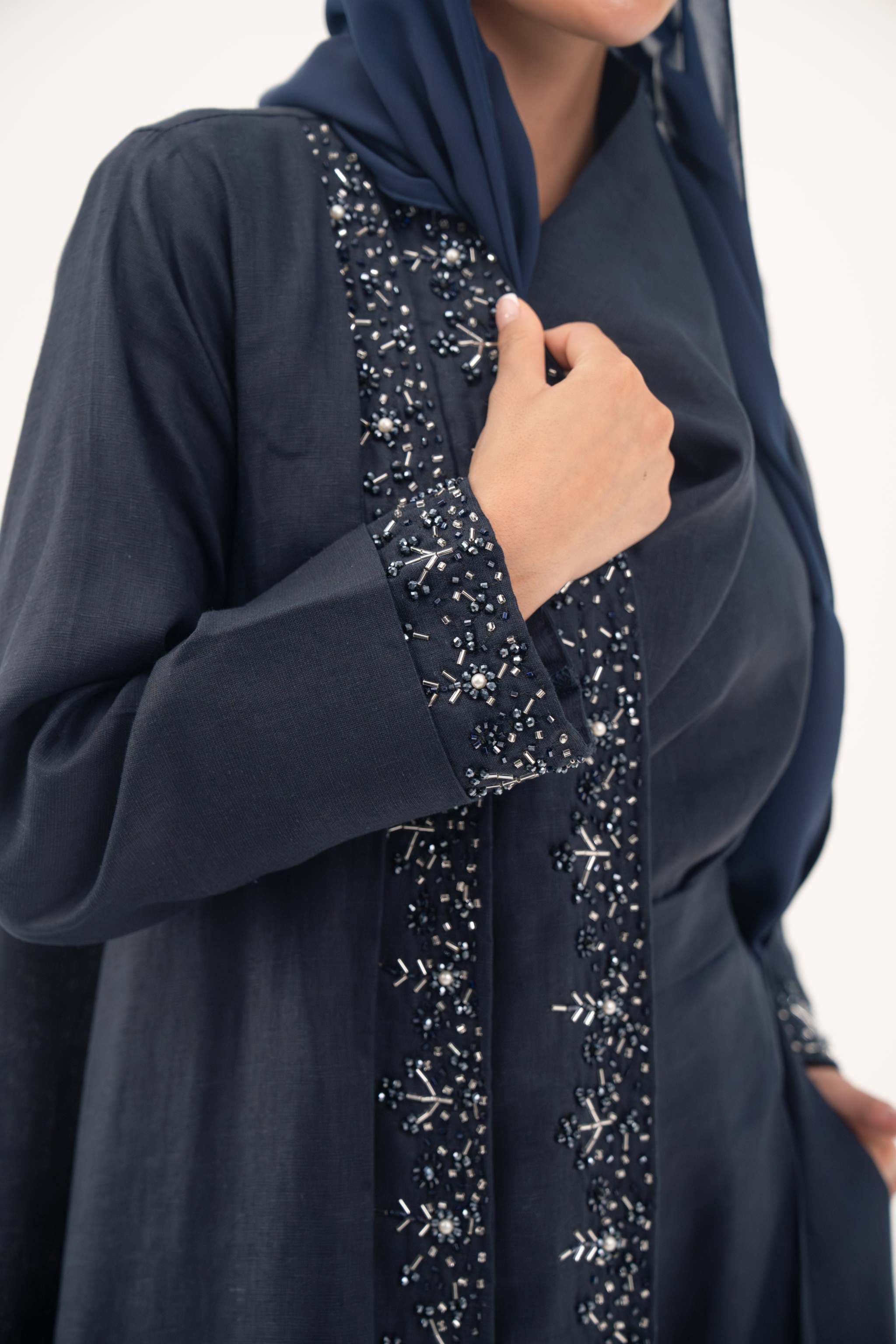 High-quality linen abaya with delicate shak beading on front panels and cuffs, open-front flowy design with structured shoulders