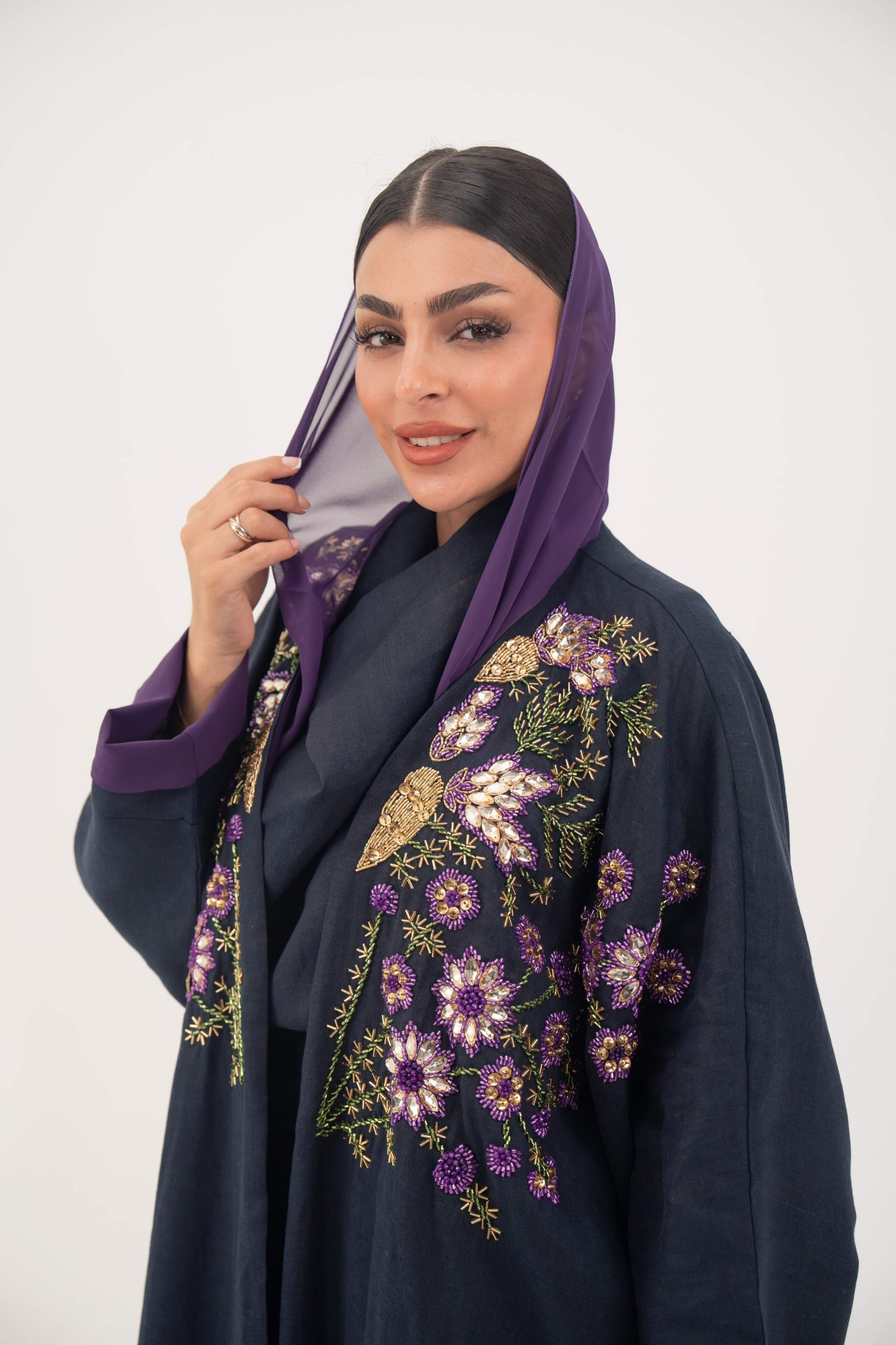 Navy blue linen-blend abaya with purple cuffs, floral hand-stitched details, and lightweight chiffon lining