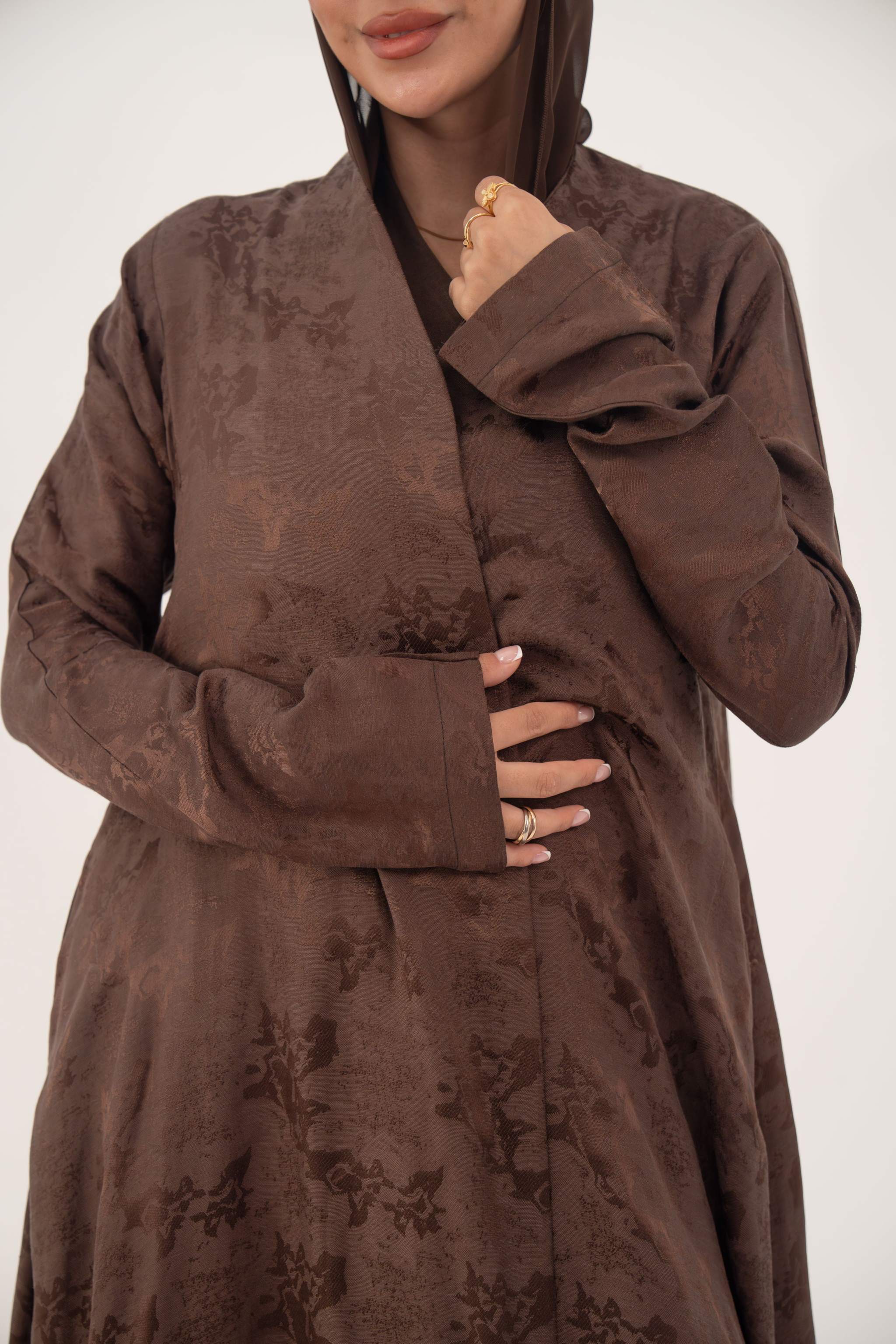 Relaxed A-line full-length cocoa brown jacquard silk abaya with subtle floral pattern and long sleeves