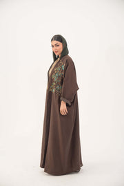 Brown bisht abaya with turquoise and gold floral embroidery, lightweight chiffon lining, and loose elegant fit for special occasions