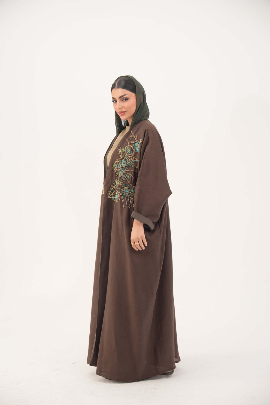 Brown bisht abaya with turquoise and gold floral embroidery, lightweight chiffon lining, and loose elegant fit for special occasions