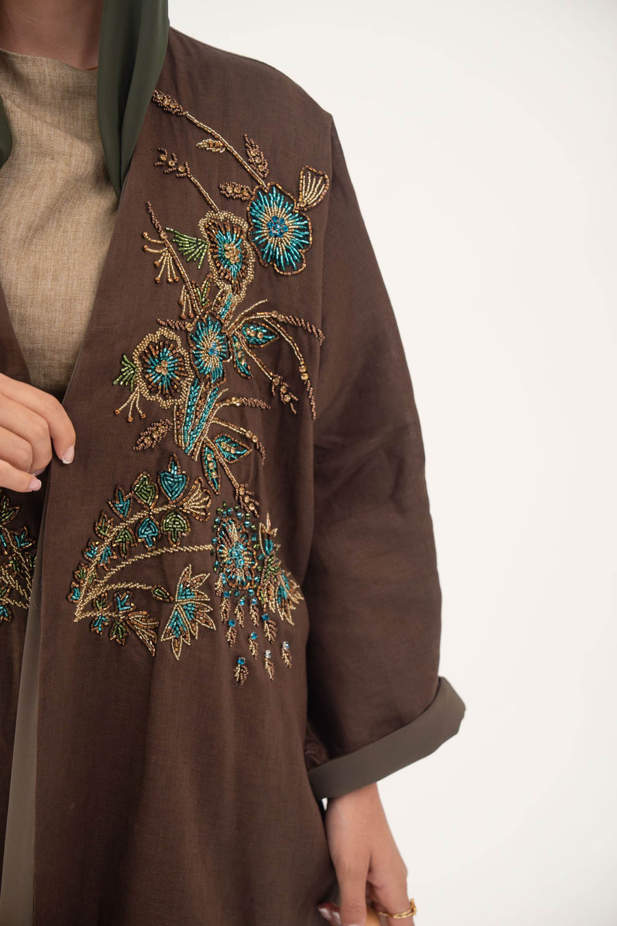 Brown bisht abaya with turquoise and gold floral embroidery, lightweight chiffon lining, and loose elegant cut for special occasions