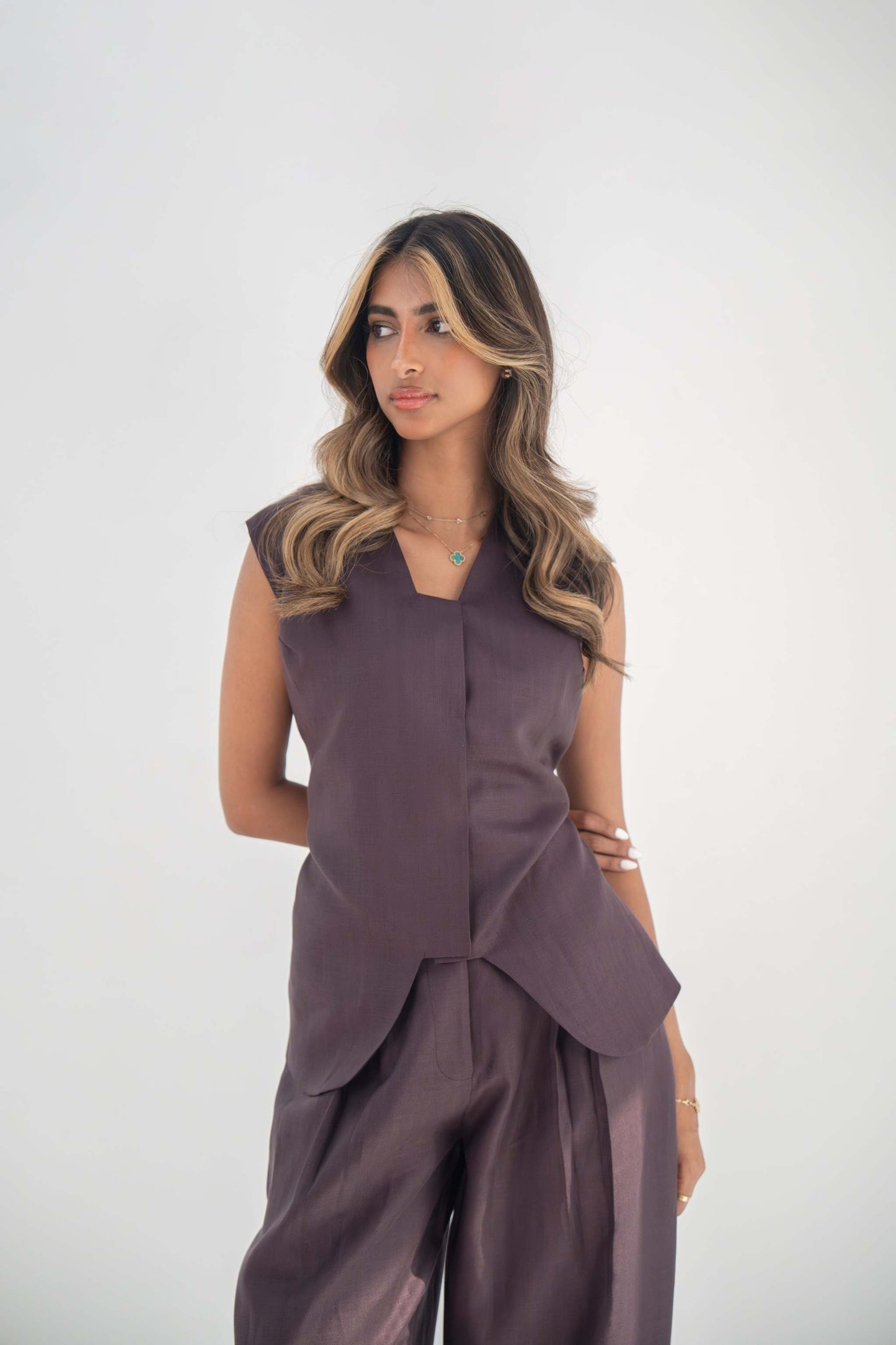 Sleeveless ube vest in high-quality twill linen blend with structured cut and hidden buttons for sleek layering.