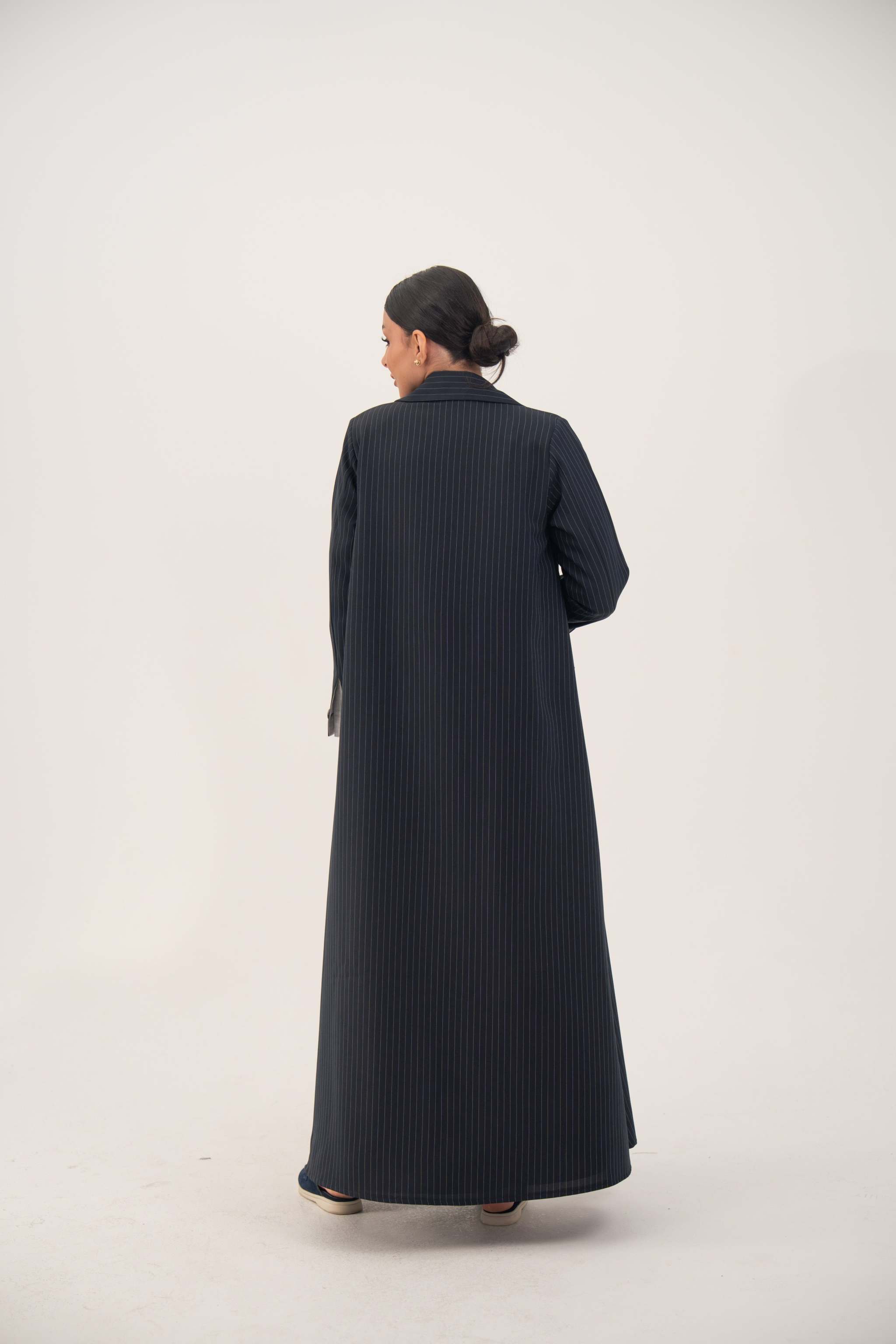 Back view of a deep navy crepe blend open-front abaya with white pinstripes, wide lapel, shoulder pads, and buttoned straight sleeves