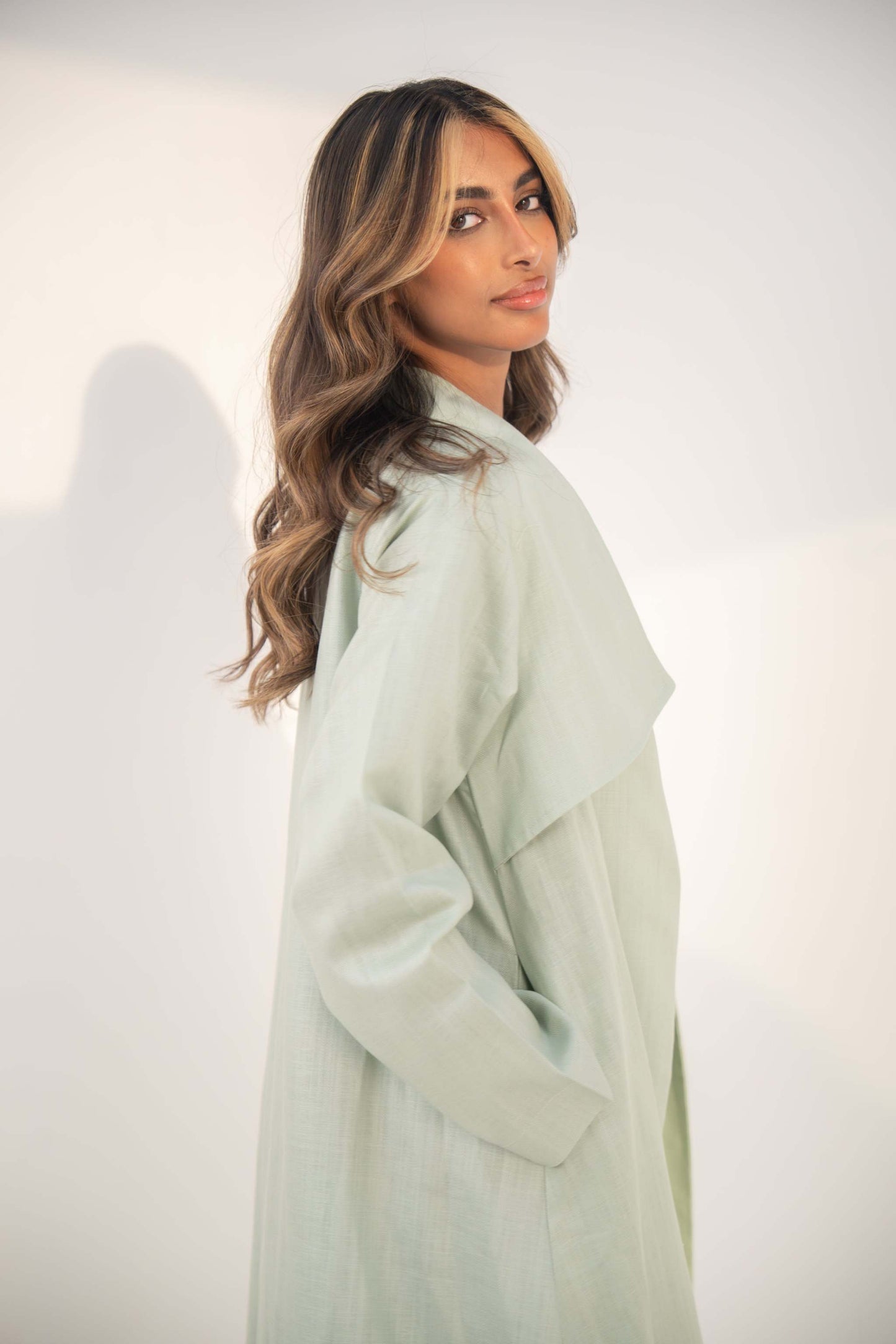 abaya crafted from soft twill linen blend in mint green with open-front design and draped collar