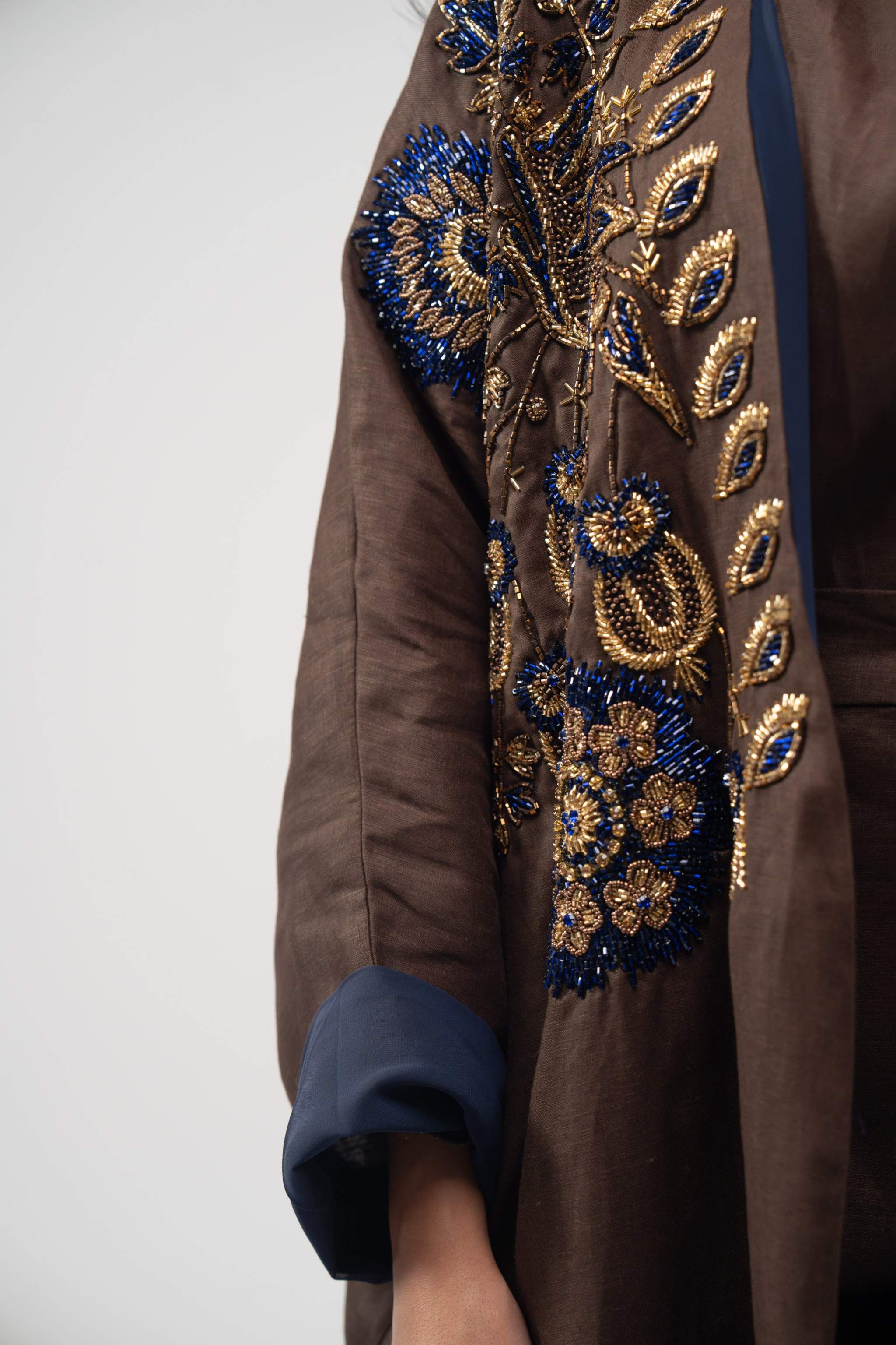 Brown linen bisht abaya with navy chiffon lining and gold and navy floral embroidery on front