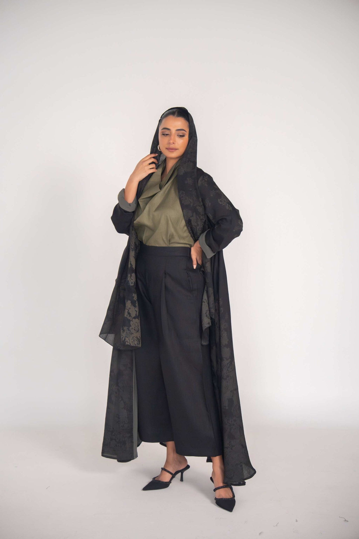 woman wearing elegant black jacquard abaya with tonal grey cuffs and soft chiffon lining, styled for modern modest fashion