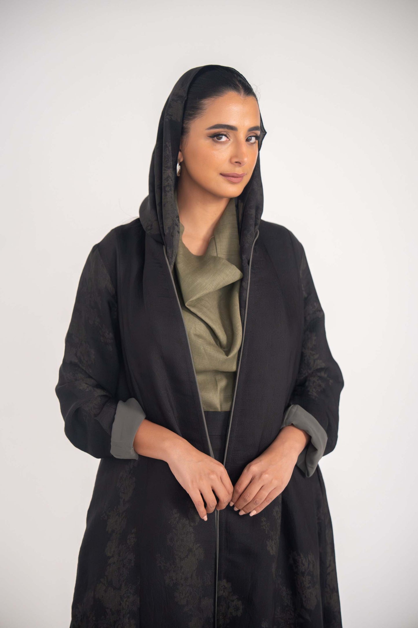 Black jacquard Olivia abaya with floral pattern, double closed cut, grey cuff accents, and soft chiffon lining for a flowy, elegant look.