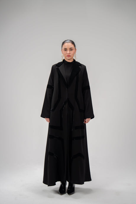 woman wearing black refined abaya with velvet detailing and silk lining