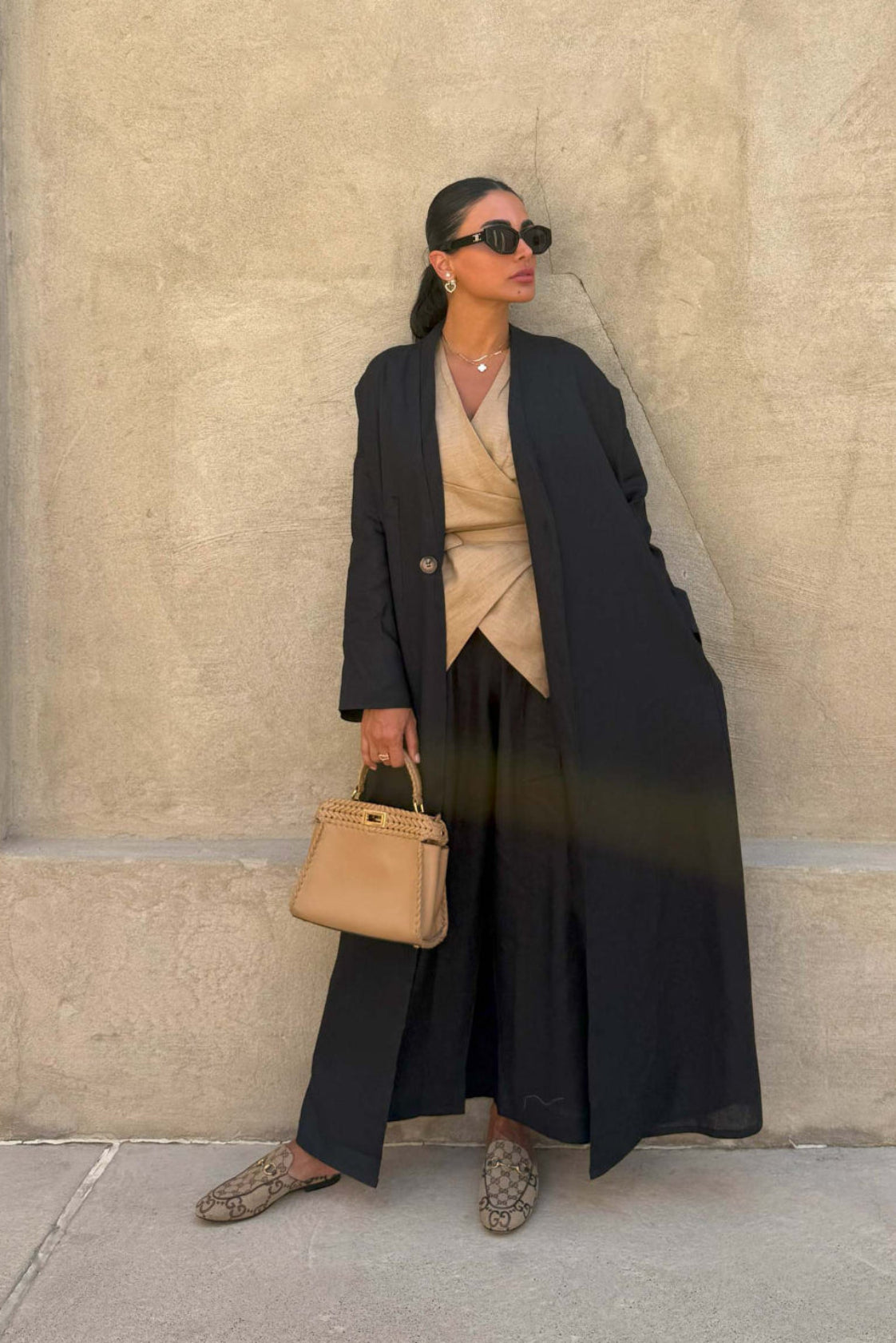 Minimalist breathable linen black abaya with straight cut and open front, styled for elegant everyday wear.
