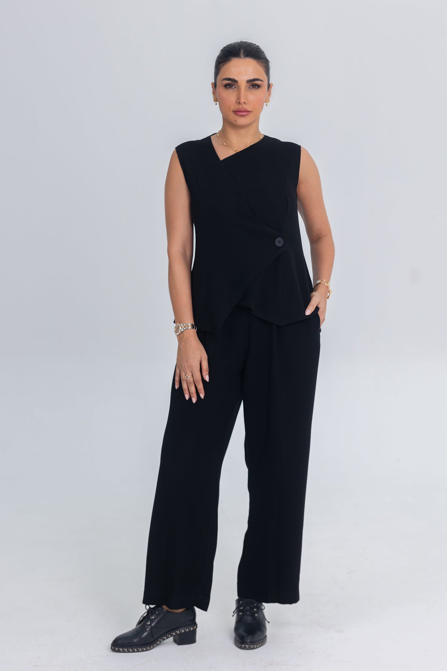 Black asymmetrical inner set with layered top and straight-cut trousers made from premium crepe fabric