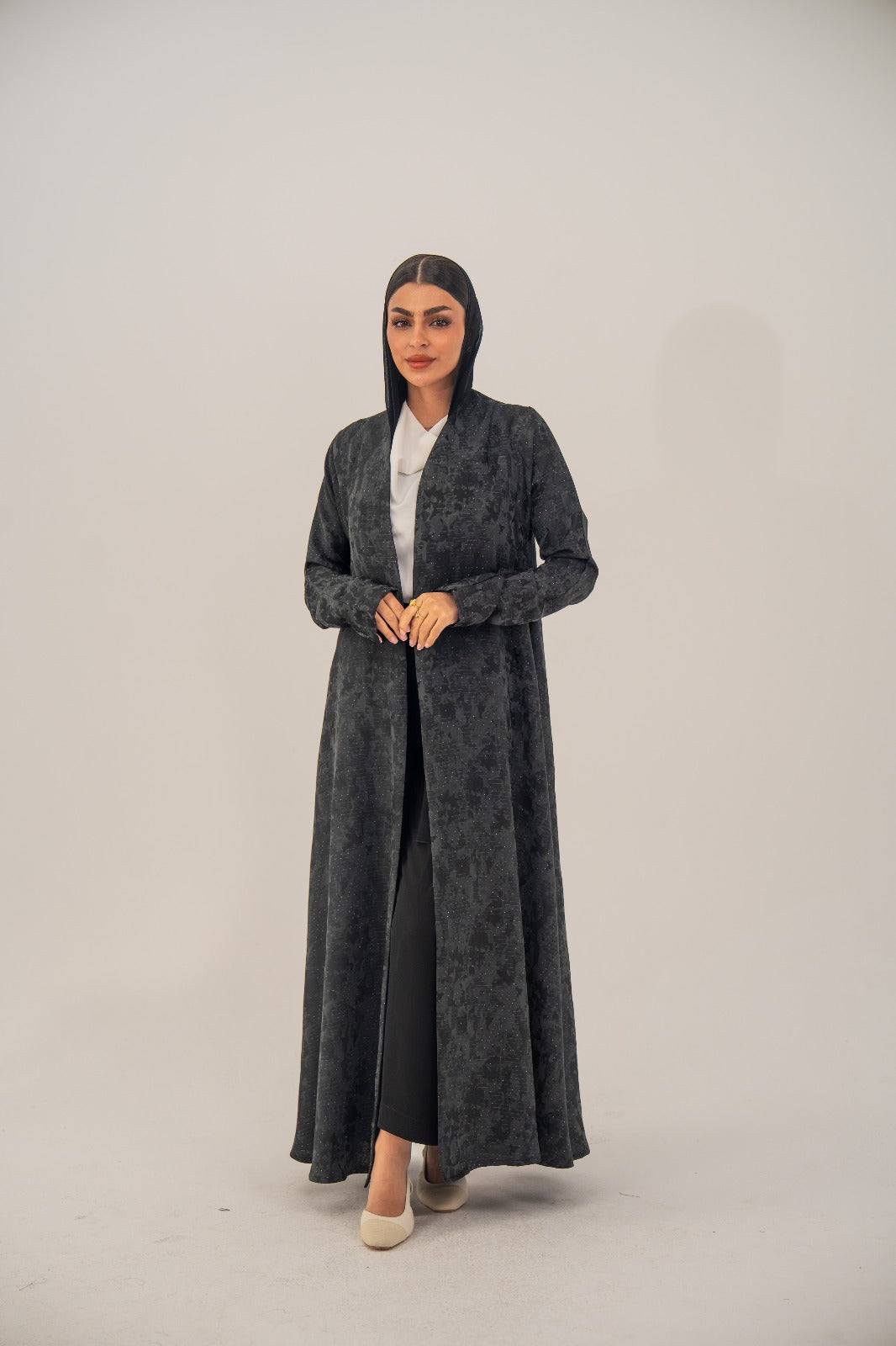 Black silk open-front abaya with subtle abstract pattern and light shimmer, charcoal gray finish.