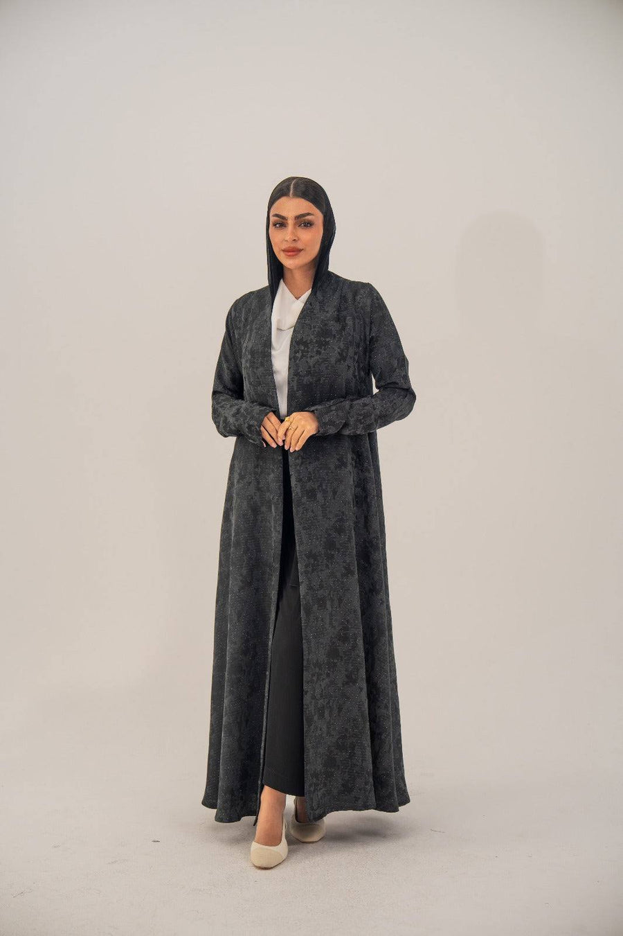 Black silk open-front abaya with subtle abstract pattern and light shimmer, charcoal gray finish.