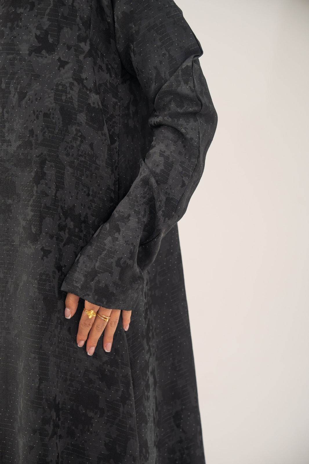 Black silk open-front abaya with subtle abstract woven pattern and light shimmer in charcoal gray finish