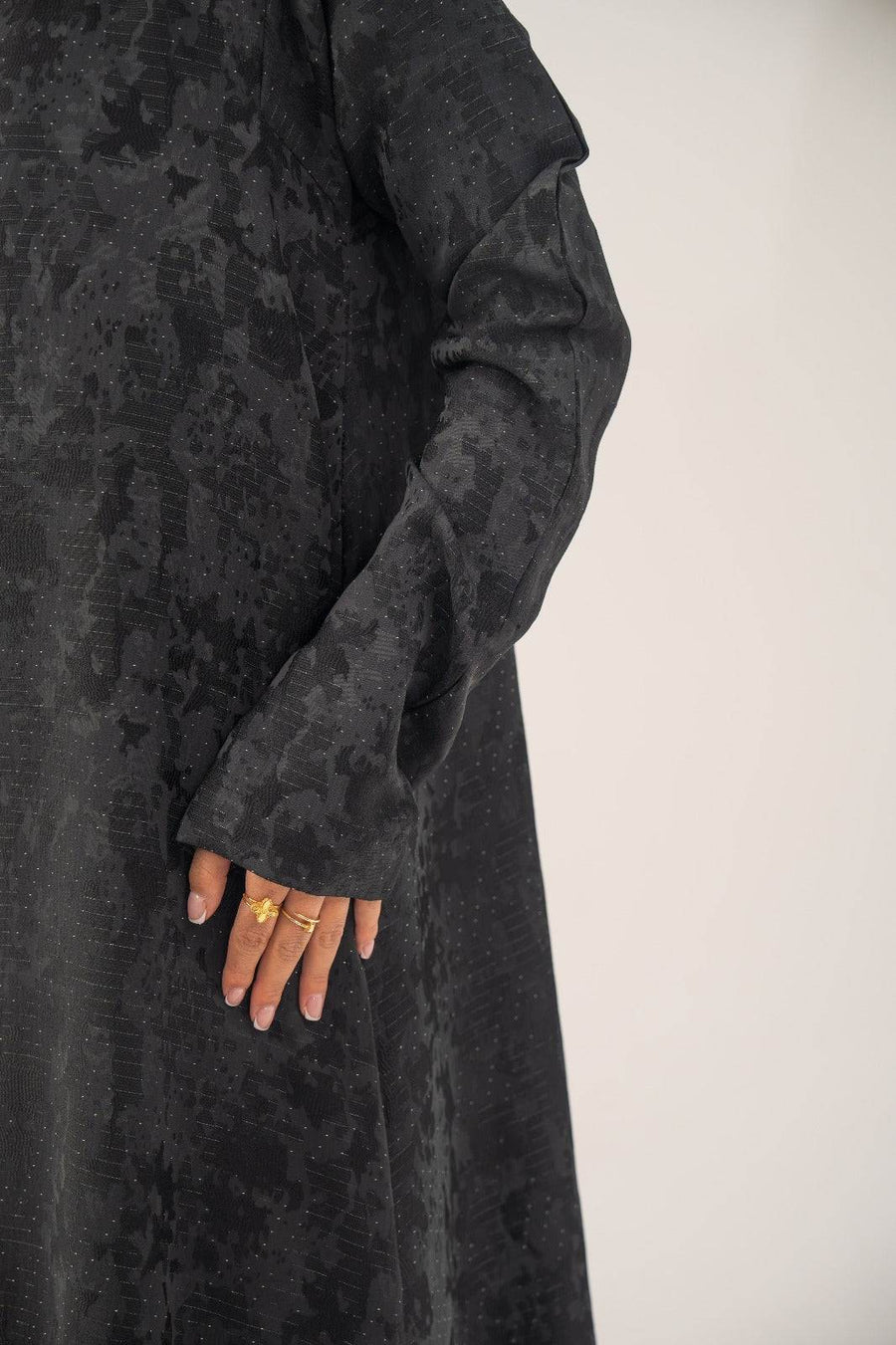 Black silk open-front abaya with subtle abstract woven pattern and light shimmer in charcoal gray finish