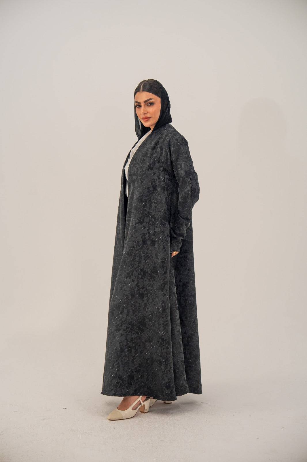Black silk open-front abaya with subtle abstract pattern and soft shimmer in charcoal gray