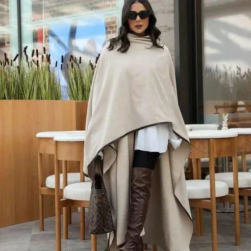 woman wearing a contemporary freesize abaya in smooth chamois fabric with leather line detailing standing indoors