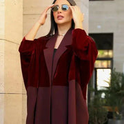 Woman wearing elegant red velvet abaya with luxurious hand embroidery and sunglasses outdoors