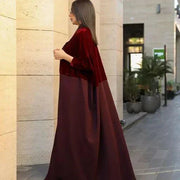 Woman wearing elegant red velvet abaya with luxurious hand embroidery and sunglasses outdoors