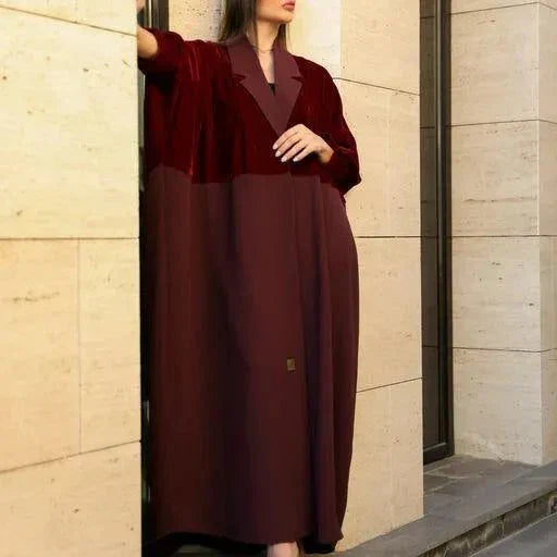 Woman wearing elegant red velvet abaya with luxurious hand embroidery and sunglasses outdoors