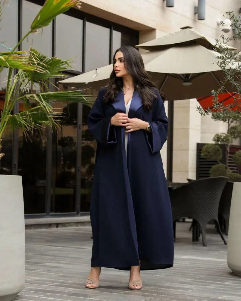Woman wearing a deep navy blue freesize blazer with crepe and mokado fabrics outdoors