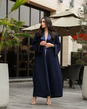 Woman wearing a deep navy blue freesize blazer with crepe and mokado fabrics outdoors
