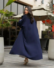 Woman wearing a deep navy blue freesize blazer with crepe and mokado fabrics outdoors