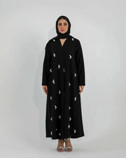 Black Luluwa abaya in soft crepe with hand-embroidered pearl-inspired details and a simple straight cut.