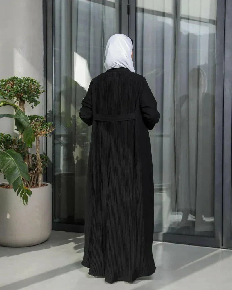 Black blazer-style abaya in crepe fabric with tailored front and soft pleats at the back, featuring sharp lapels and a clean silhouette.