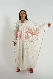 White linen bisht abaya with red hand embroidery and red trim, styled with a red handbag and sandals - Strawberry Cheesecake