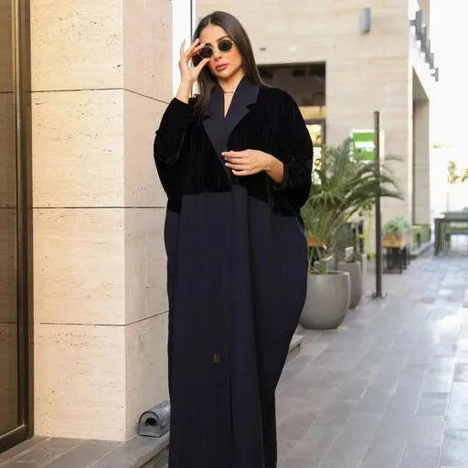 Woman wearing navy blue freesize blazer with velvet and crepe fabric mix, styled with sunglasses in an outdoor urban setting