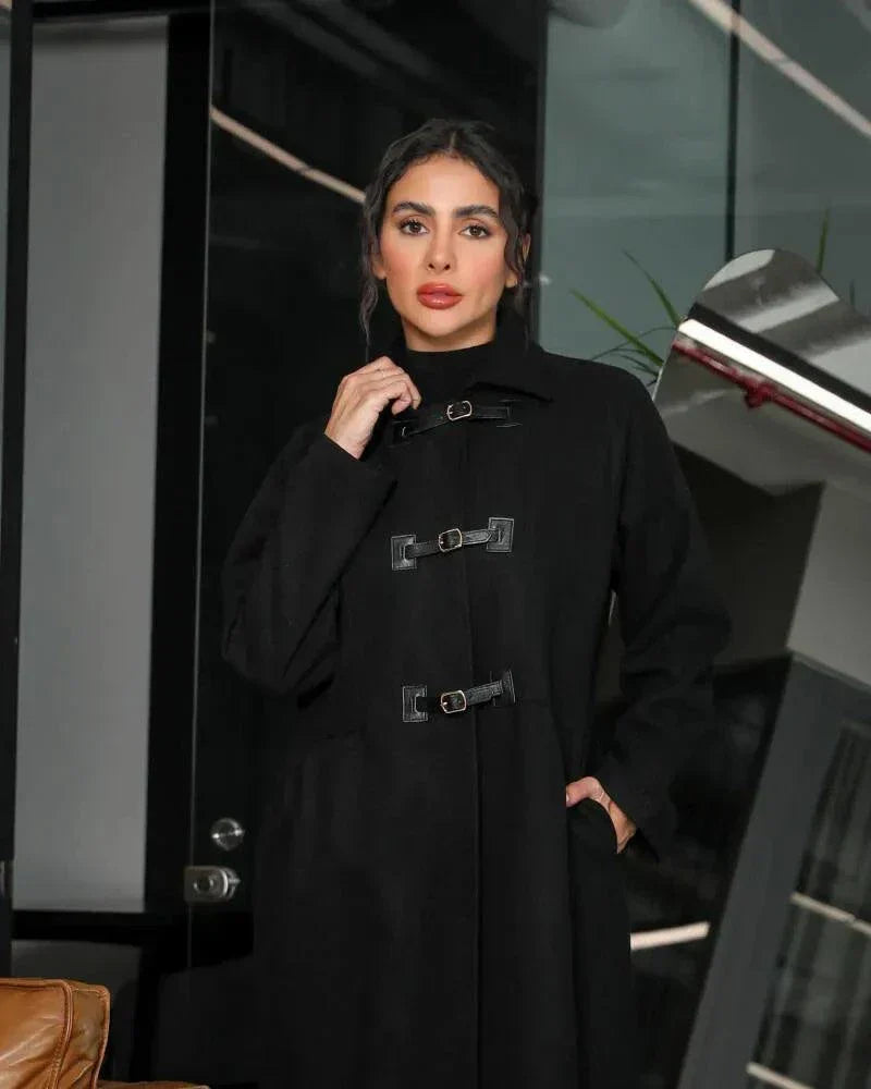 Harbor black abaya in structured wool with high-neck collar and three buckle closures for winter layering and side pockets