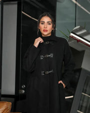 Harbor black abaya in structured wool with high-neck collar and three buckle closures for winter layering and side pockets