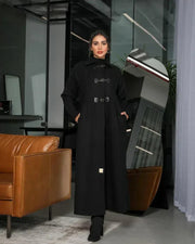 Harbor black abaya in structured wool with high-neck collar and three buckle closures for winter layering and side pockets