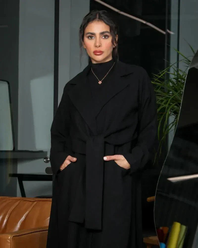 minimal black blazer-style abaya with lapel collar, full sleeves, and matching belt in smooth crepe fabric