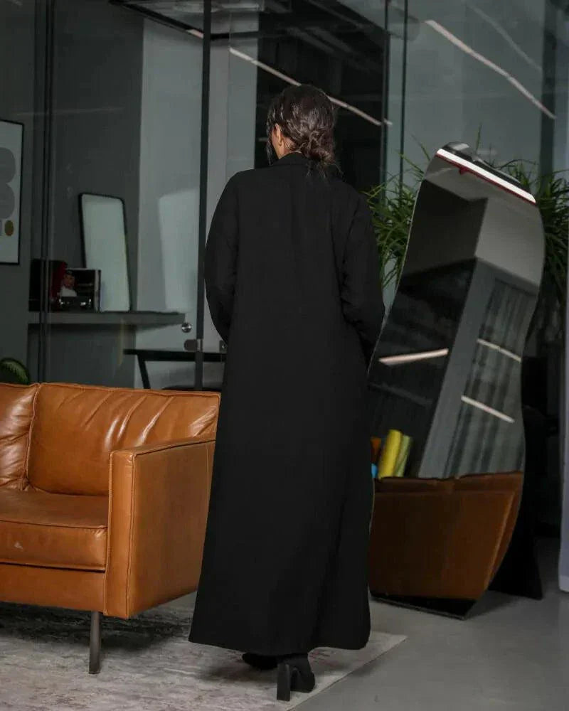 minimal black blazer-style abaya with lapel collar, full sleeves, and matching belt in smooth crepe fabric