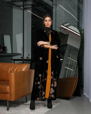 luxurious black velvet abaya with gold and beige geometric embroidery and bold orange chiffon lining in a relaxed silhouette