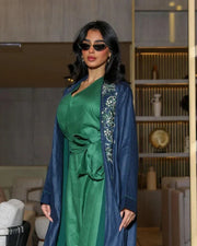 Caspia navy blue abaya in structured linen with green and silver embroidery on shoulders and cuffs, styled with contrasting green innerwear.