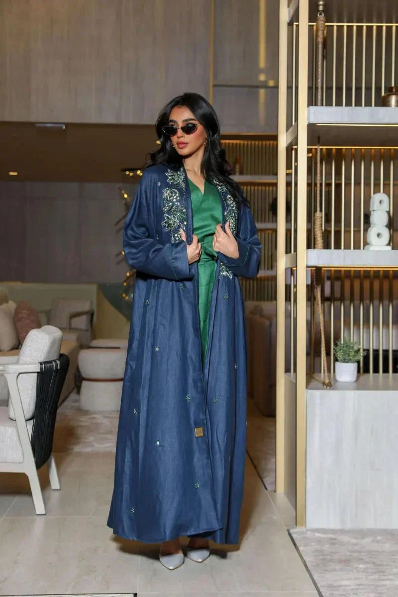 Caspia navy blue abaya in structured linen with green and silver embroidery on shoulders and cuffs, styled with contrasting green innerwear.
