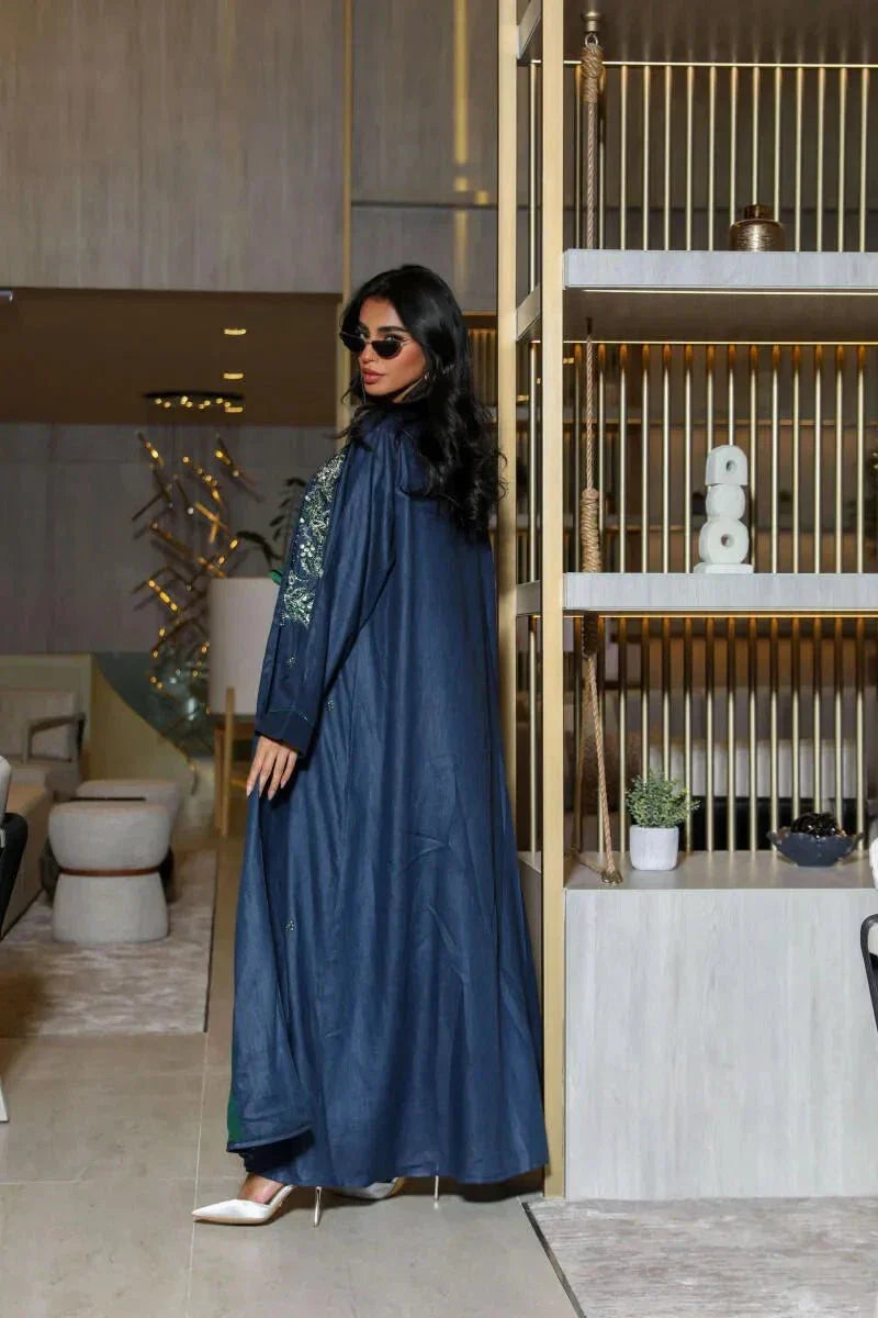Caspia navy blue abaya in structured linen with green and silver embroidery on shoulders and cuffs, styled with contrasting green innerwear.